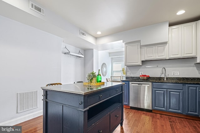 kitchen featuring dishwasher, a center island, dark hardwood / wood-style flooring, sink, and white cabinetry