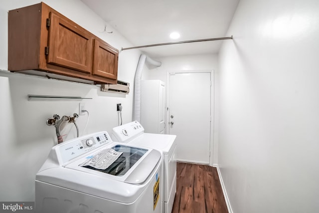 laundry room with cabinets, independent washer and dryer, and dark hardwood / wood-style floors