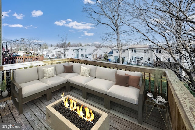 wooden terrace with a gazebo and an outdoor living space with a fire pit