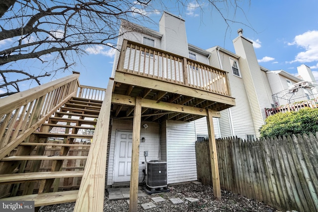 back of property with cooling unit and a deck