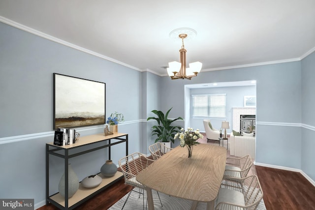 dining area featuring ornamental molding, wood-type flooring, and an inviting chandelier