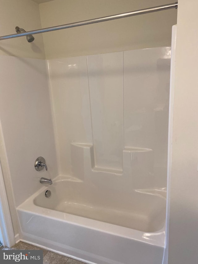 bathroom featuring shower / washtub combination and tile patterned flooring