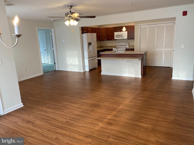 unfurnished living room featuring ceiling fan and dark wood-type flooring