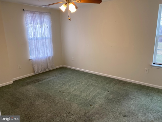 carpeted empty room featuring ceiling fan