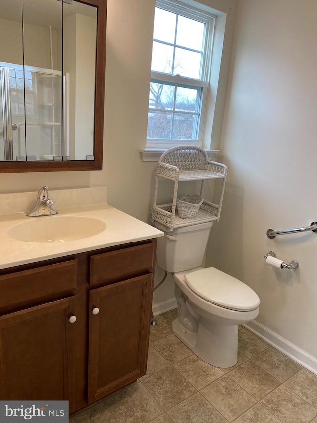 bathroom featuring toilet, vanity, and tile patterned flooring