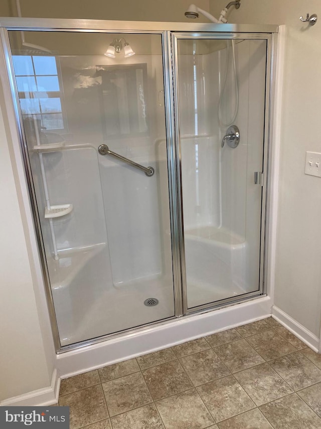 bathroom with a shower with shower door