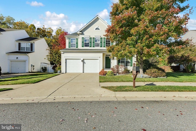 view of property with a garage and a front yard