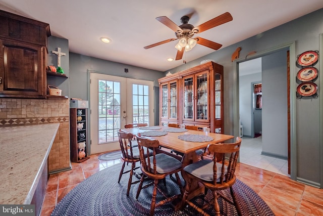 tiled dining room with french doors and ceiling fan