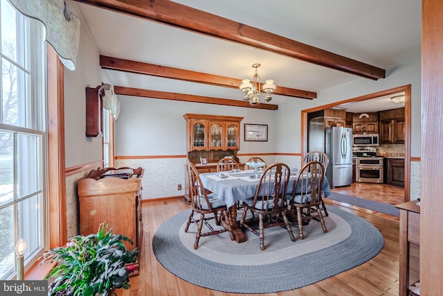 dining area featuring a chandelier and light wood-type flooring