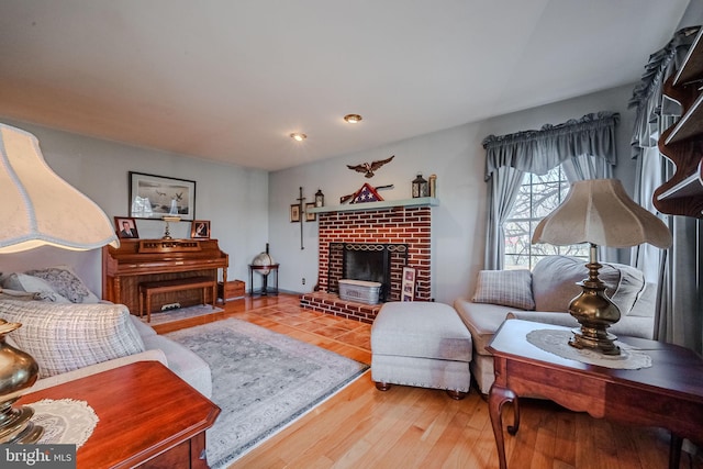 living room featuring wood-type flooring and a fireplace