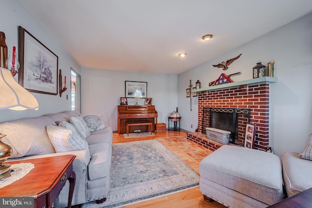 living room featuring a brick fireplace