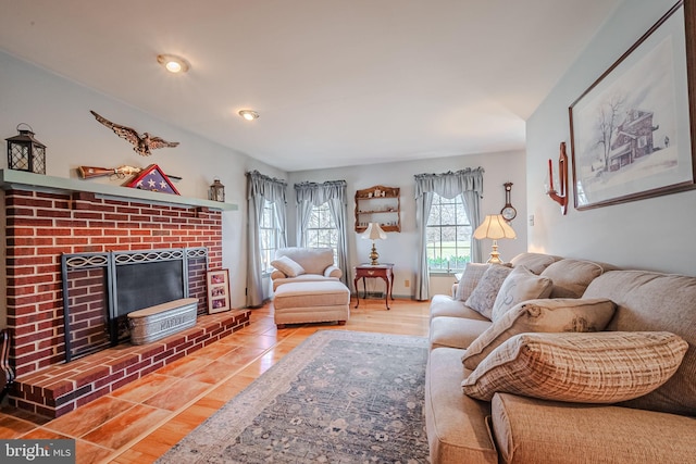 living room featuring a brick fireplace