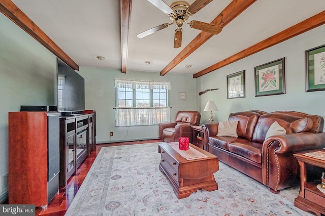 living room featuring beamed ceiling and ceiling fan