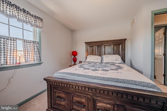 bedroom featuring light colored carpet