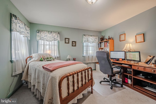 bedroom featuring light carpet and multiple windows