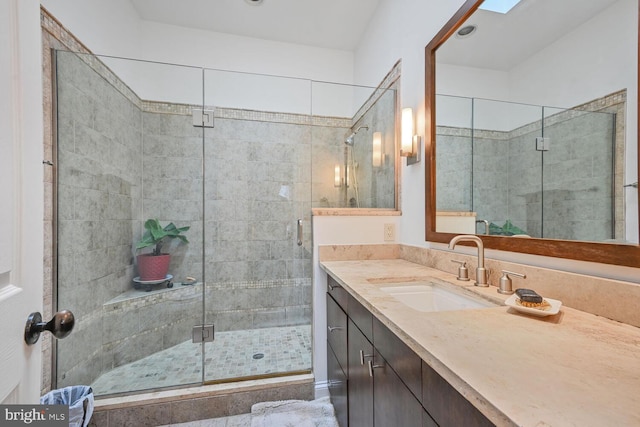 full bathroom with a stall shower and vanity