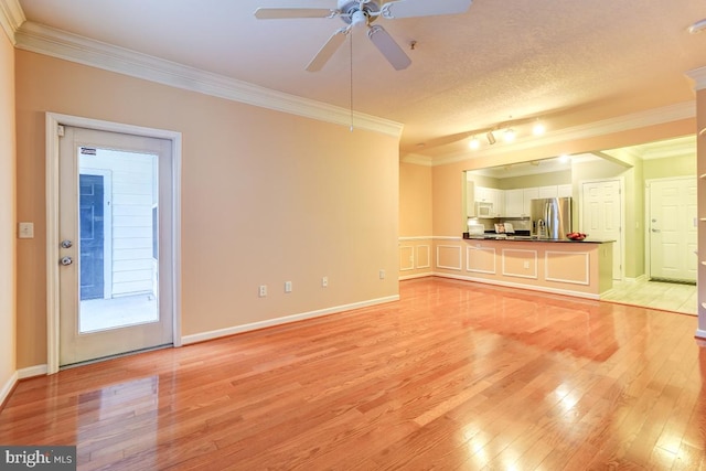 unfurnished living room featuring a textured ceiling, ceiling fan, light wood-type flooring, and crown molding