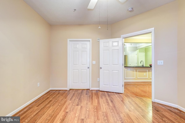 interior space featuring ceiling fan, sink, and light hardwood / wood-style floors