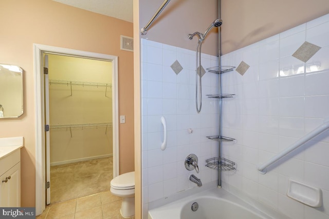 full bathroom with tile patterned flooring, vanity, toilet, and tiled shower / bath combo