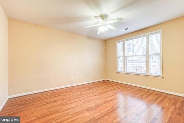 empty room with light wood-type flooring and ceiling fan