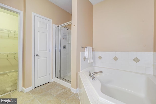 bathroom featuring tile patterned floors and shower with separate bathtub