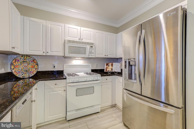 kitchen featuring white cabinets, decorative backsplash, and white appliances