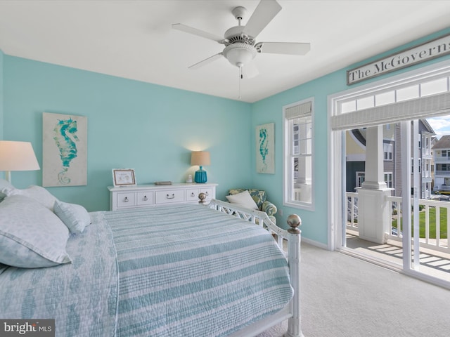 carpeted bedroom featuring access to outside, multiple windows, and ceiling fan