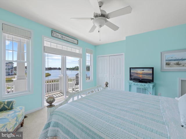 carpeted bedroom with ceiling fan and a closet