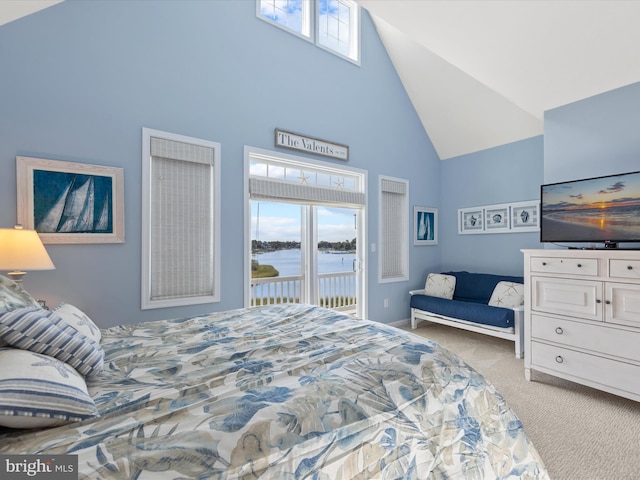 bedroom with access to outside, high vaulted ceiling, and light colored carpet