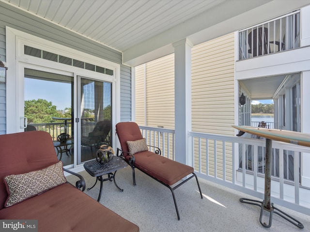 sunroom / solarium featuring a water view