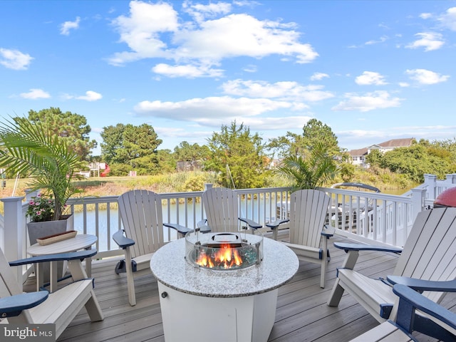 wooden deck featuring a fire pit