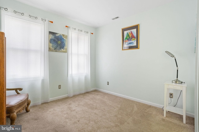 living area with light carpet