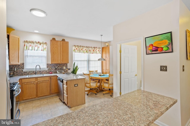 kitchen with kitchen peninsula, light stone counters, stainless steel appliances, sink, and hanging light fixtures