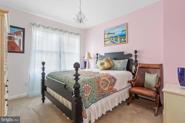 bedroom featuring light carpet and an inviting chandelier