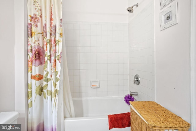 bathroom with shower / bath combo with shower curtain