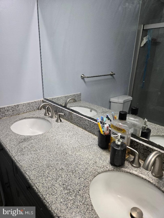 bathroom featuring walk in shower, vanity, and toilet