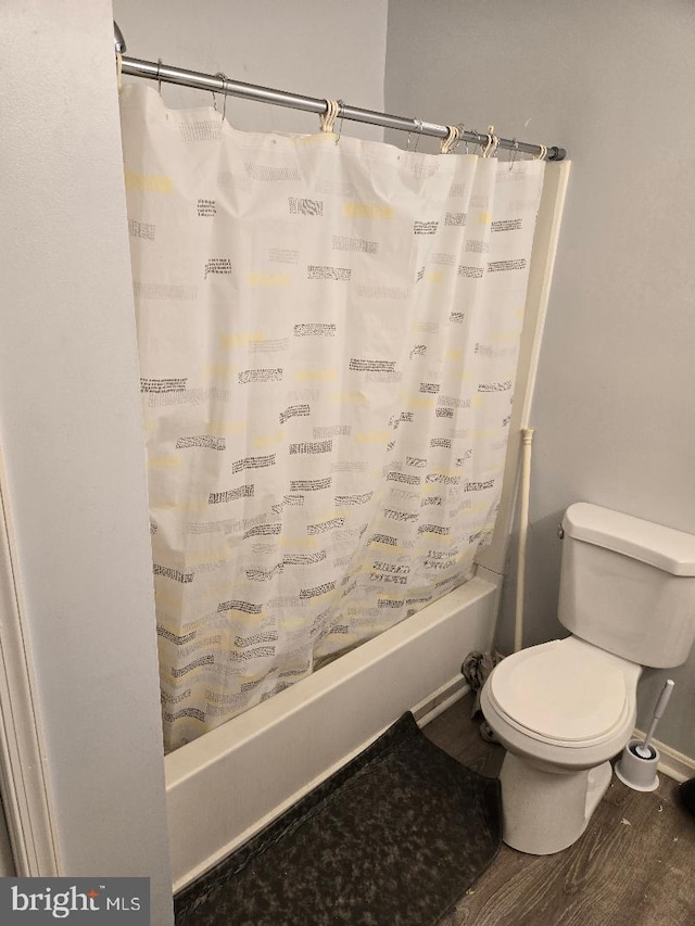 bathroom with wood-type flooring, toilet, and shower / bath combination with curtain