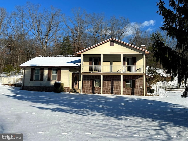 split level home with brick siding and a balcony