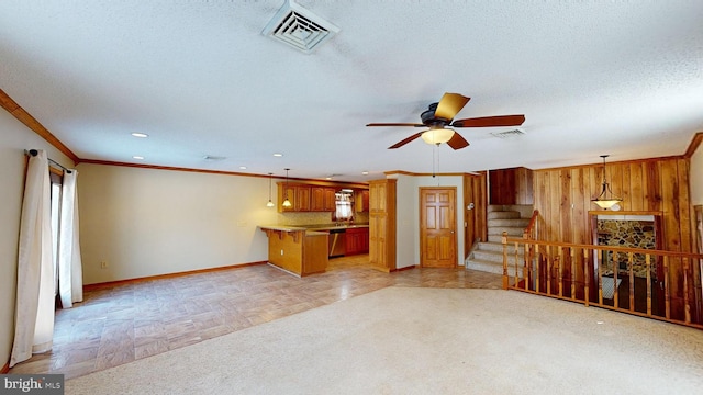 unfurnished living room featuring stairs, visible vents, and crown molding