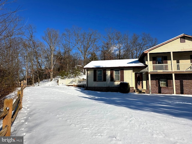 view of snow covered exterior featuring a balcony