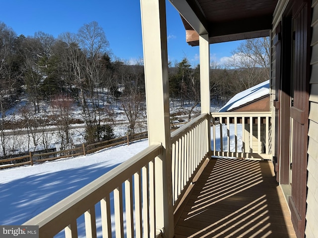 view of snow covered back of property