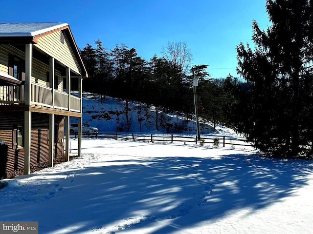 snowy yard with a balcony