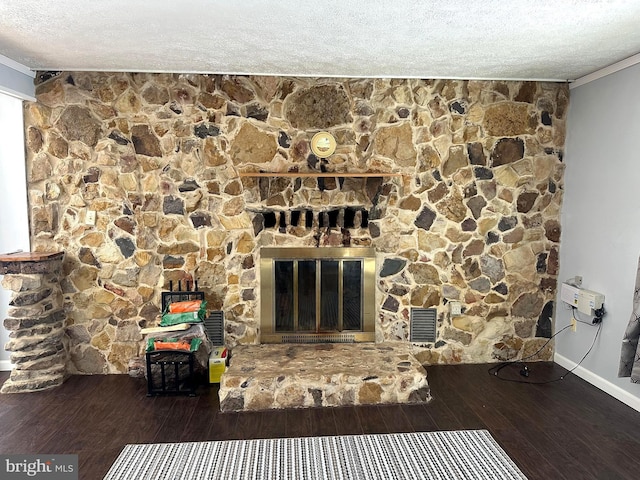 unfurnished living room featuring dark wood-style flooring, a fireplace, visible vents, and crown molding