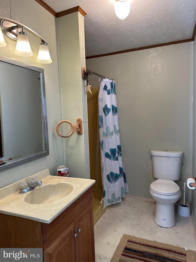 bathroom featuring a textured ceiling, ornamental molding, a shower stall, and vanity