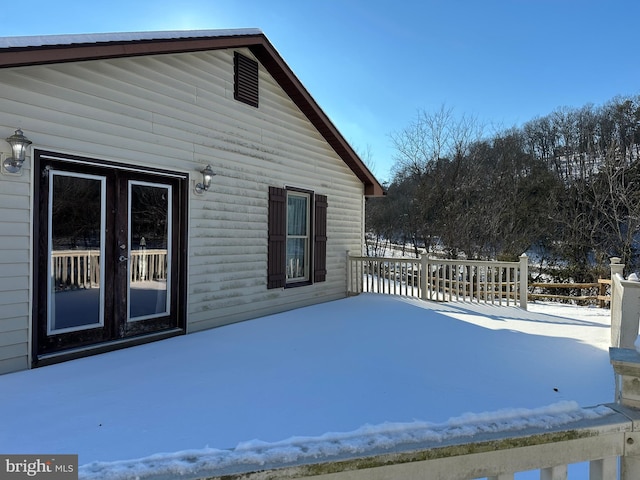 view of snow covered exterior featuring french doors