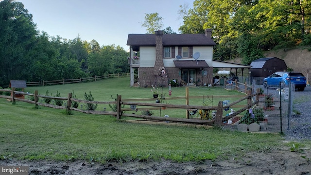 exterior space featuring brick siding, a chimney, fence, a rural view, and a front lawn