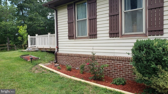 view of home's exterior featuring a lawn and fence