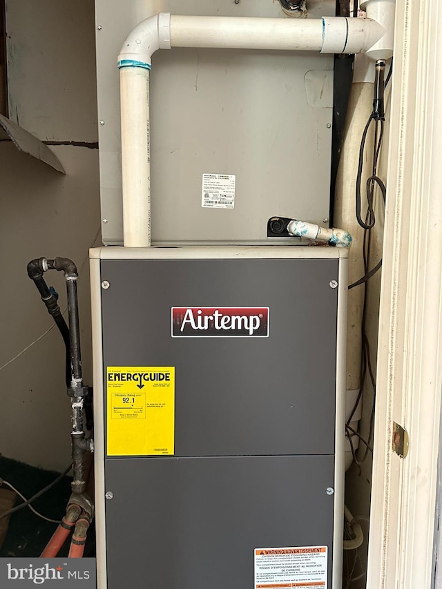 utility room featuring heating unit