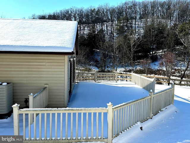 snow covered pool featuring central AC unit