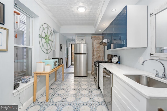 kitchen with sink, stainless steel appliances, white cabinetry, and ornamental molding